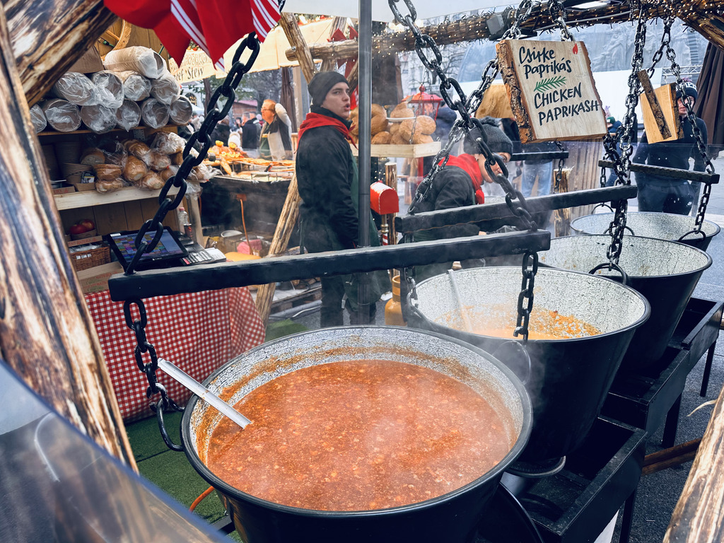 Goulash soup in three big cauldrons at the Vörösmarty Square Christmas Market in Budapest, Hungary.