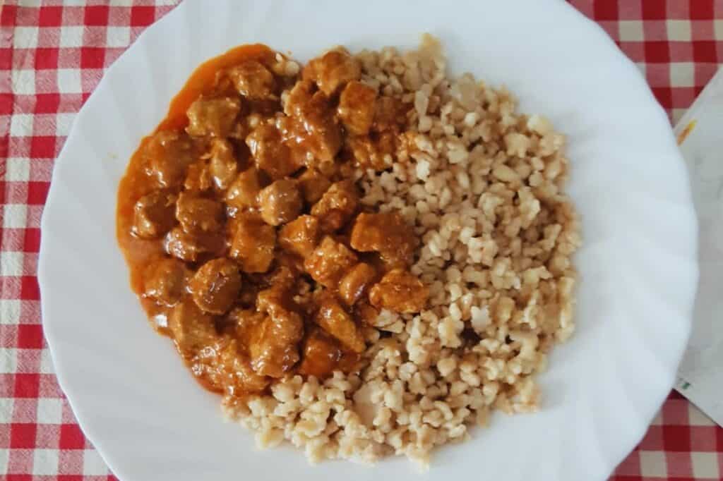 Pörkölt, a traditional Hungarian dish, on a plate on a table.