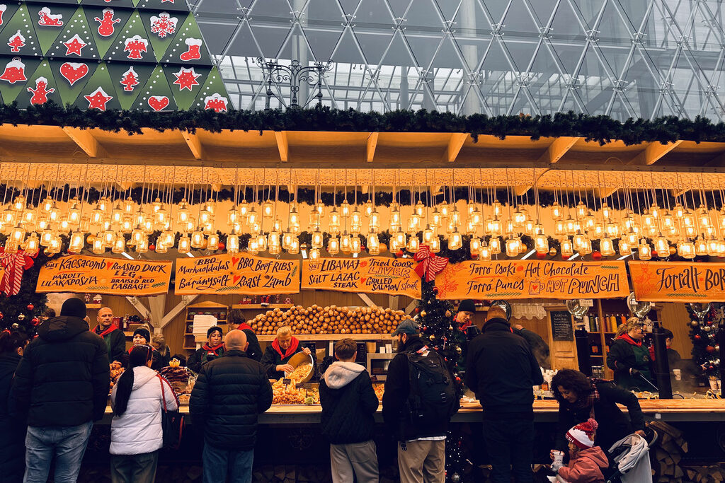 People at a food stall at the Christmas Market in Budapest on Vorosmarty Square.