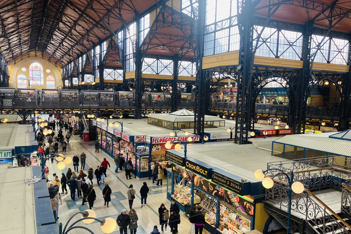 People shopping by the stalls at the Central Market Hall in Budapest, Hungary.